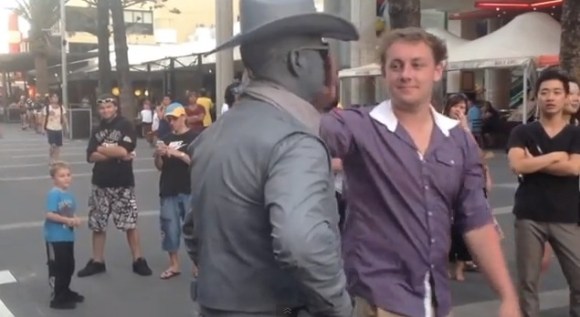 Guy gets punched by street performer